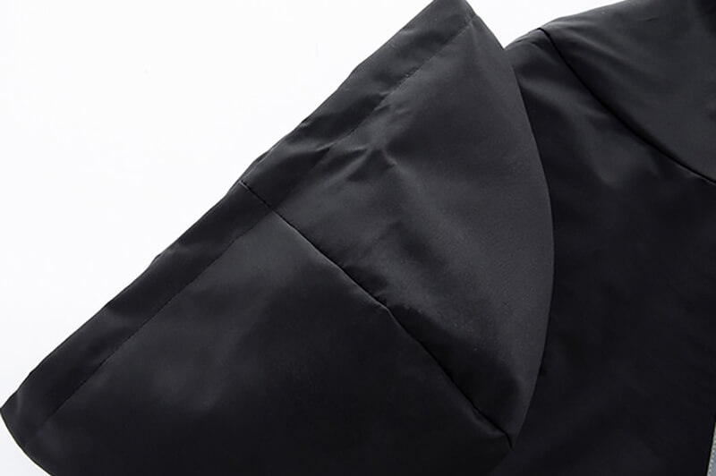 Close-up of black hooded sports men's jacket with reflective strips, made of durable polyester for comfort and protection.